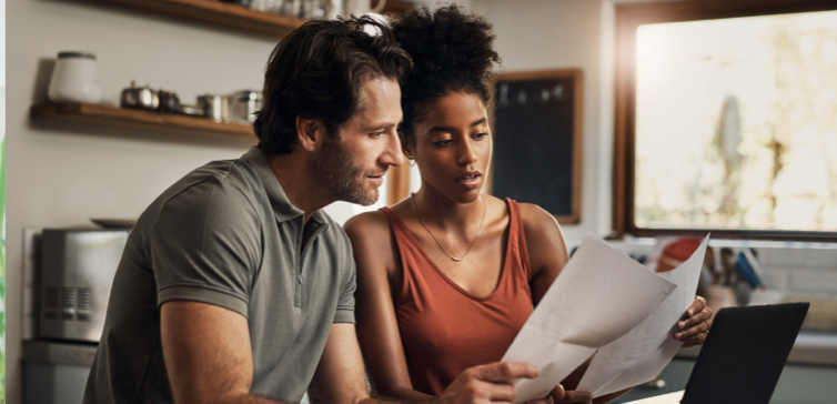 Norton LifeLock man and woman looking at tax papers