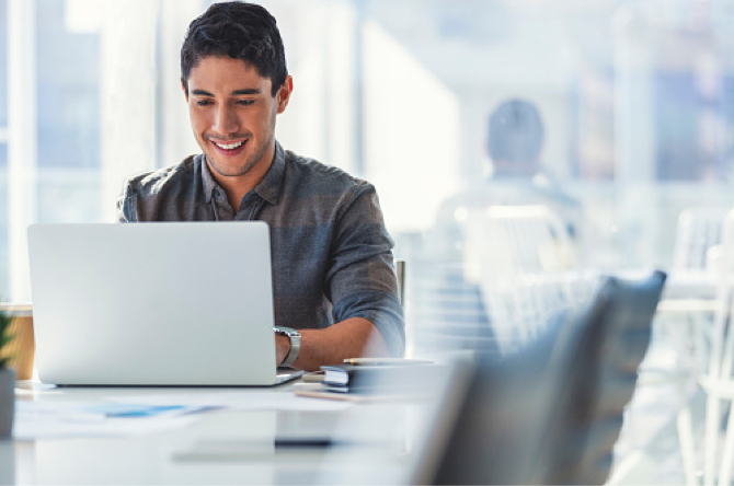 Smiling man using laptop